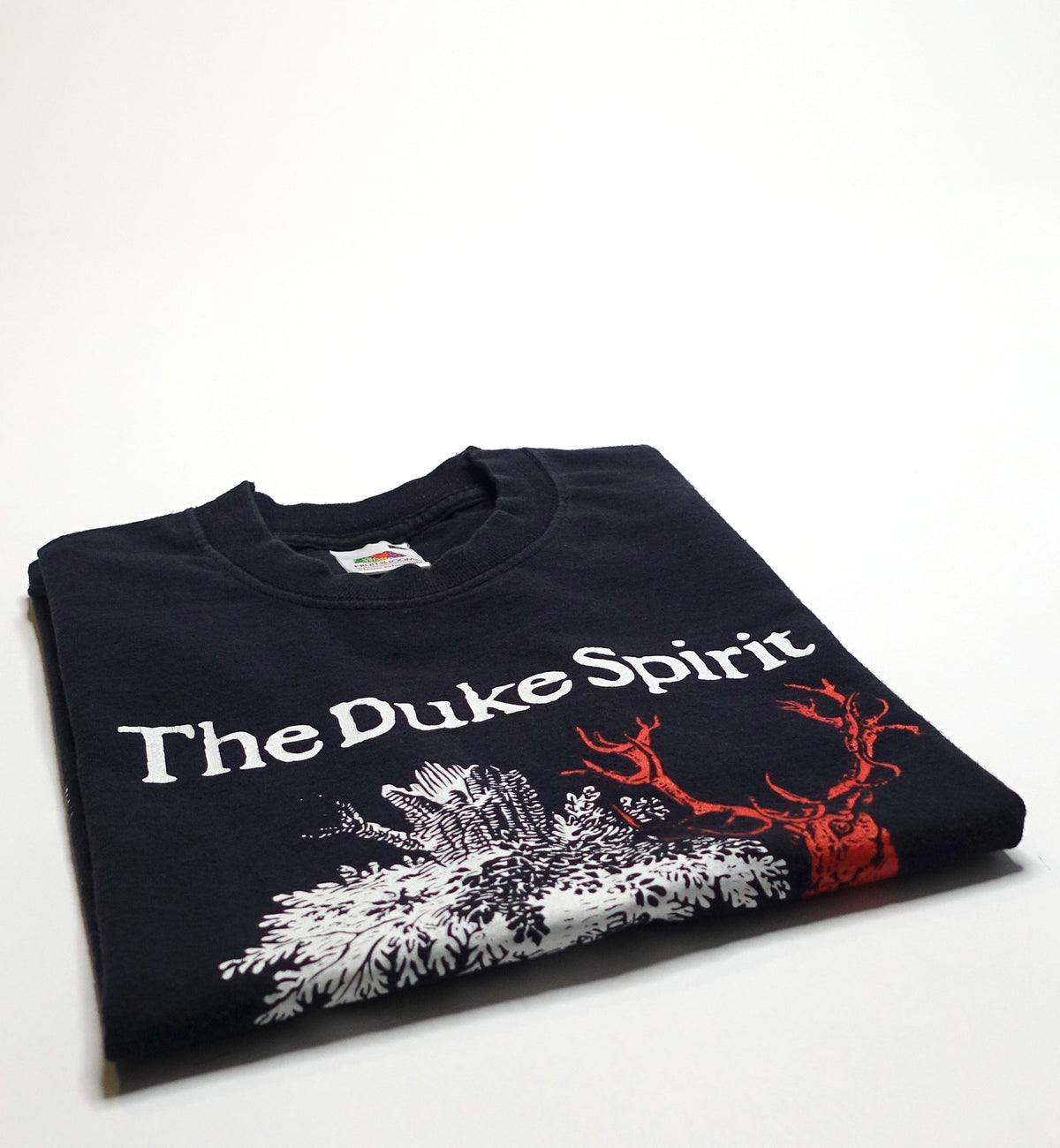 A black Duke Spirit band T-shirt with a graphic design in the center, folded and displayed on a plain background.